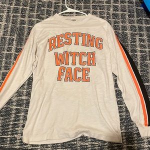 A Victoria’s Secret  long sleeve with words on front “resting which face”
